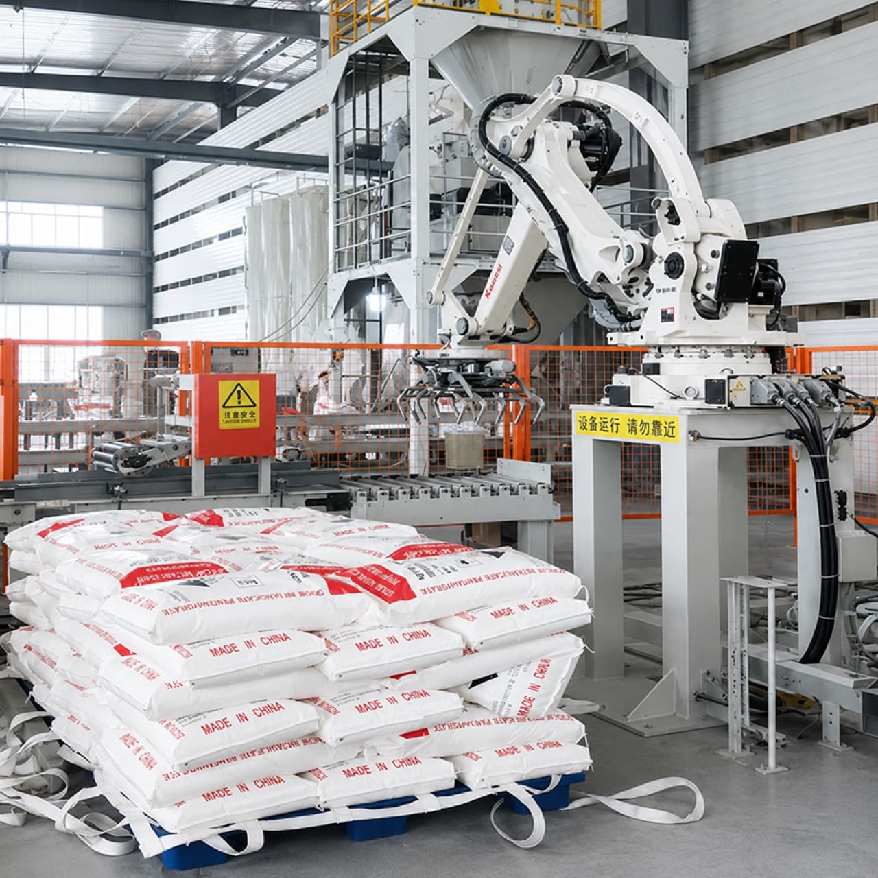 Robot arm palletizing sealed sodium metasilicate bags marked Made in China