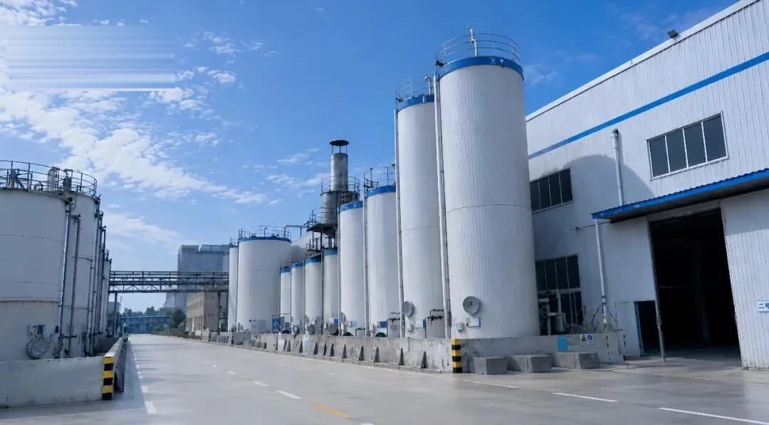 Row of on-site storage tanks along the plant road at the Zhongzhi facility