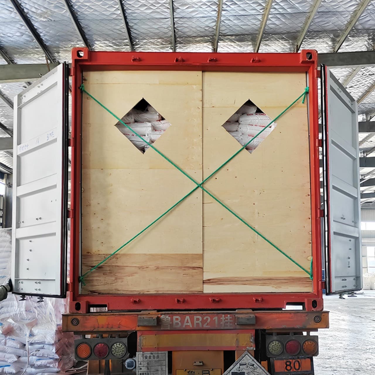 Export container with strap bracing securing the sodium metasilicate cargo