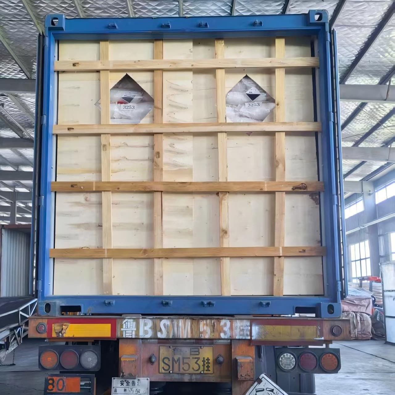 Export container with timber bracing and UN 3253 Class 8 placards for sodium metasilicate