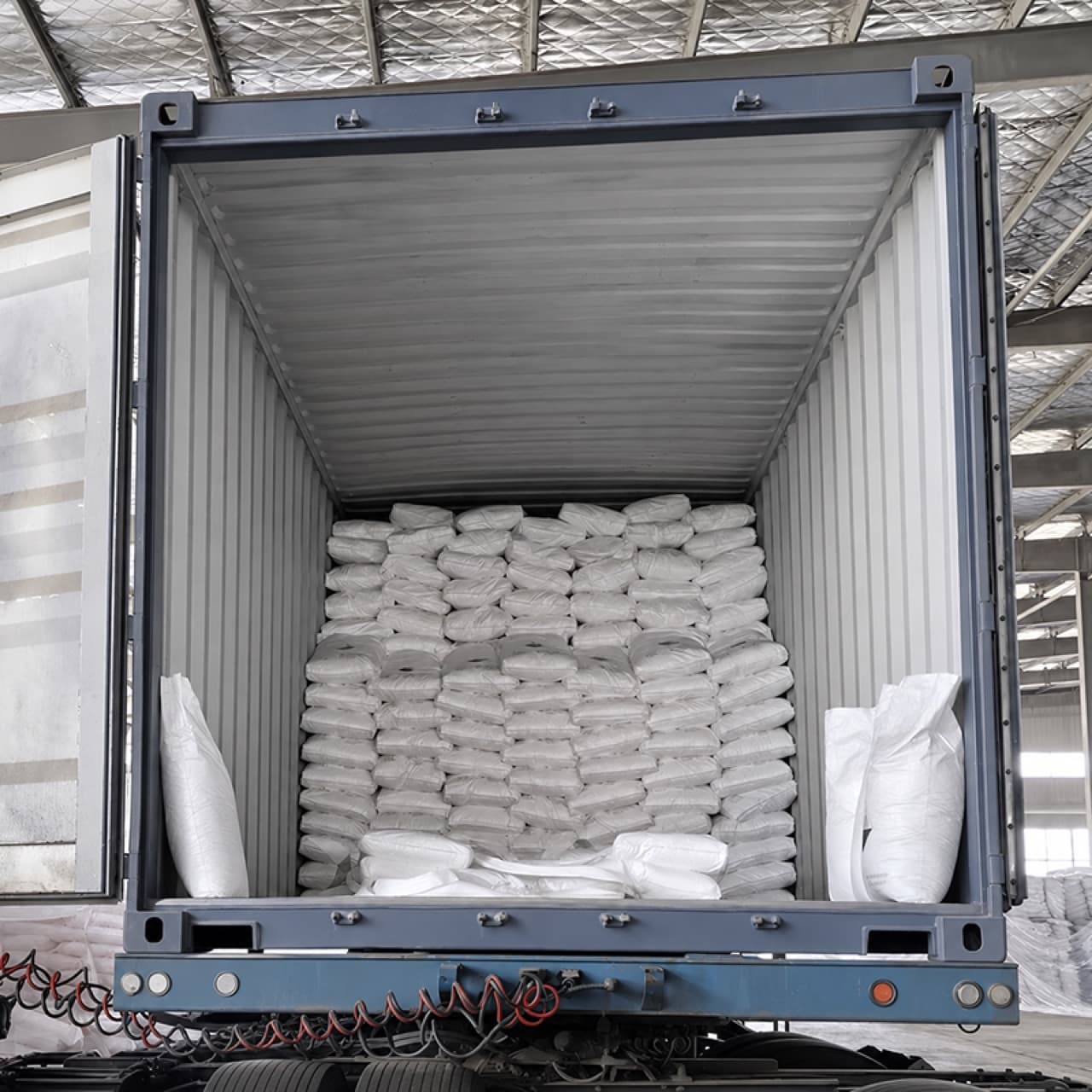 Sodium metasilicate bags stacked inside an export container before dispatch