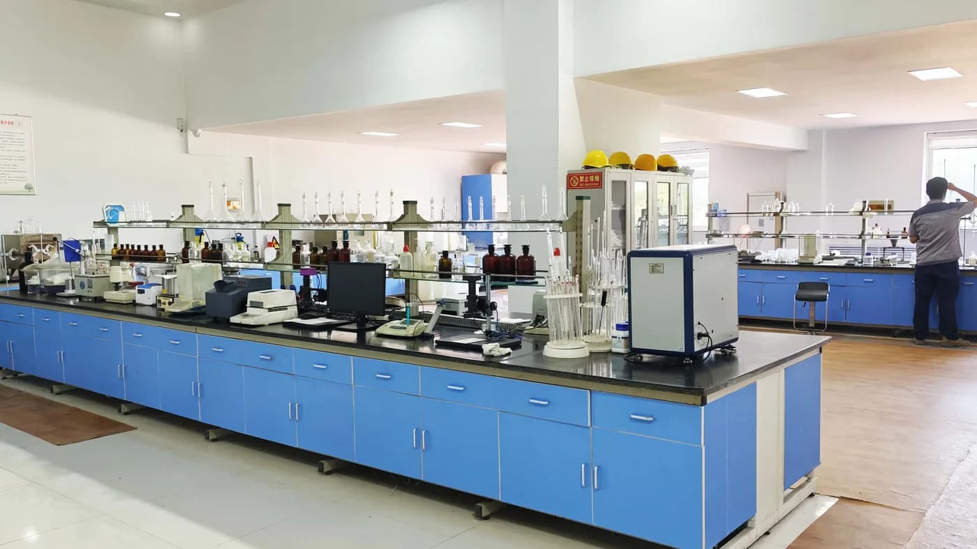 Quality-control laboratory room with instrument bench, volumetric glassware racks and reagent storage